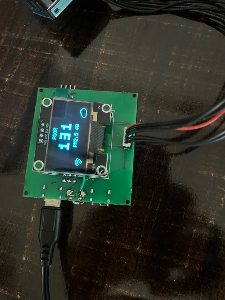Air quality monitor displaying a POOR air quality alert with PM2.5 reading and WiFi status