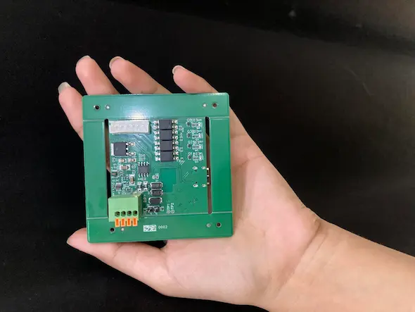 Back of the curtain controller PCB showing QR-coded serial number for production traceability and frame mounting holes
