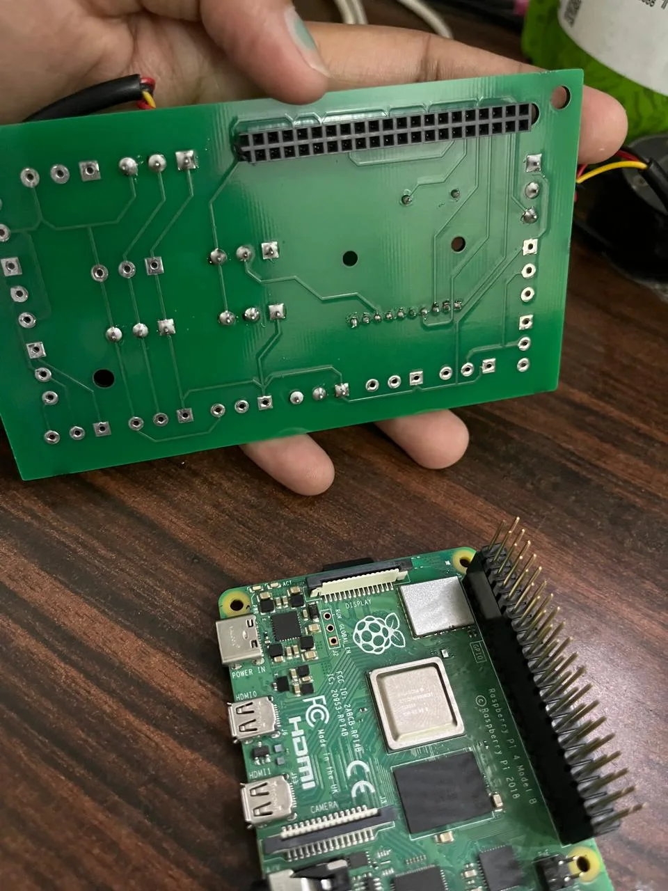 Custom Raspberry Pi HAT showing 40-pin GPIO header connecting to Raspberry Pi 4 Model B
