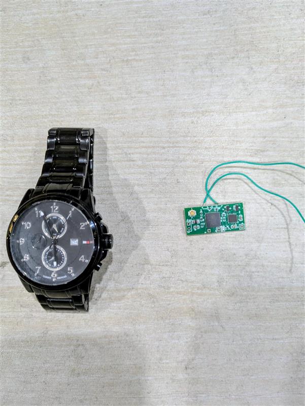 Custom nRF Wearable PCB next to a wristwatch for scale